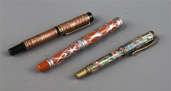 Three ornate fountain pens, cased